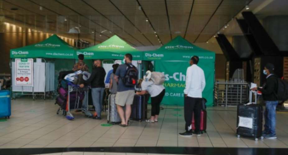 Travellers queue for Covid tests at Johannesburg airport on November 27, 2021, after several countries banned flights from South Africa following the discovery of a new Covid-19 variant.  By Phill Magakoe AFP