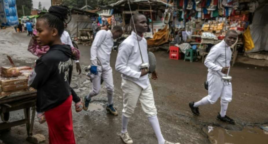 Tsavora Fencing Mtaani Club members head to training in Nairobis Mathare informal settlement.  By LUIS TATO (AFP)