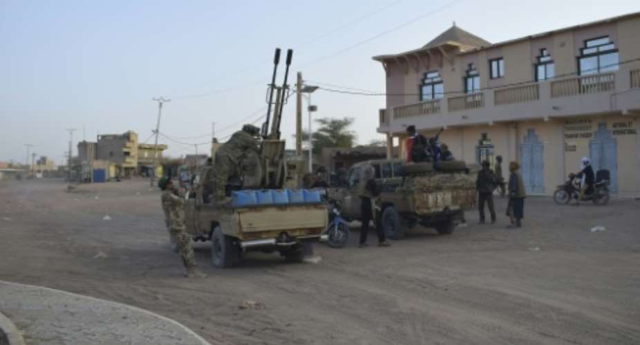 Tuareg rebels of the Azawad Liberation Front (FLA) ride on pickup trucks in Kidal after seizing the city in northern Mali.  By - (AFP)