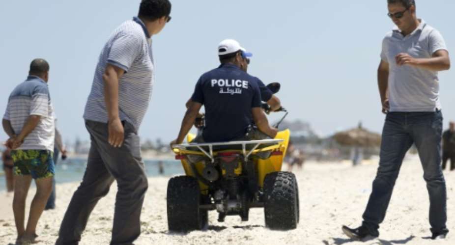 Police patrol the beach in front of the Riu Imperial Marhaba Hotel in Port el Kantaoui, on the outskirts of Sousse south of Tunisia's capital Tunis, on June 27, 2015.  By Kenzo Tribouillard AFPFile