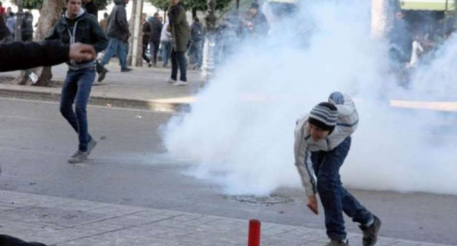 Tunisian protestors clash with security forces outside the Interior Ministry in Tunis, on February 7, 2013.  By Khalil AFP