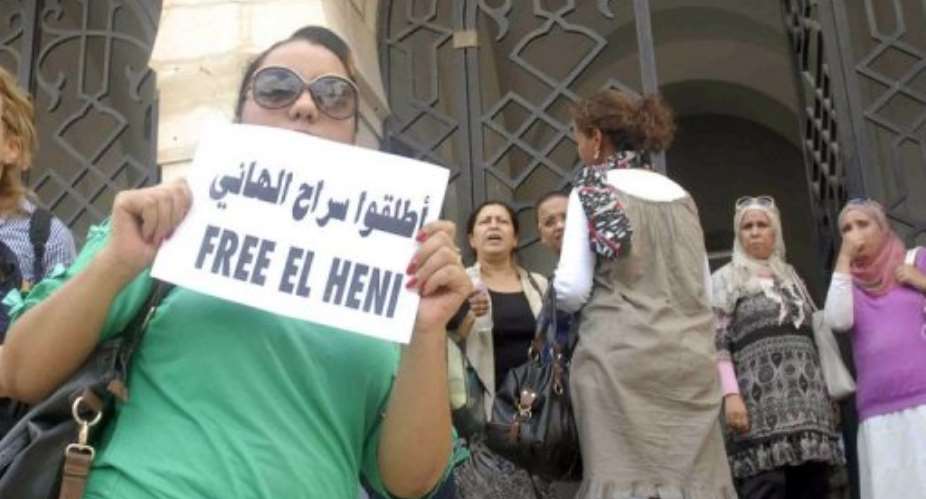 A Tunisian woman protests outside Tunis courthouse against the detention of Zied el-Heni on September 13, 2013.  By Salah Habibi AFP
