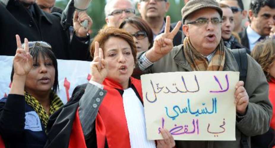 General Secretary of the National Union of Magistrates Raoudha Labidi (C) holds a sign that reads in Arabic,  No to political interference in the judiciary during a demonstration on January 15, 2014 in Tunis.  By Fethi Belaid (AFP)