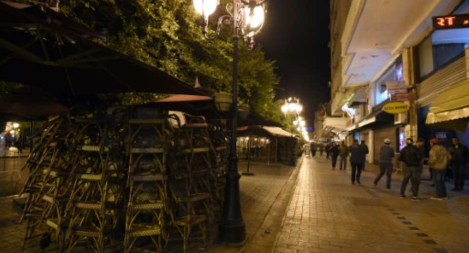 Restaurants are closed on November 26, 2012 on Habib Bourguiba Avenue in the centre of Tunis due to a curfew put in place since the attack against a bus transporting presidential guards that killed 12 people.  By Fethi Belaid (AFP/File)