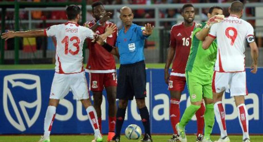 Referee Rajindraparsad Seechurn C tries to stop an argument during the 2015 African Cup of Nations quarter-final football match between Equatorial Guinea and Tunisia in Bata on January 31, 2015.  By Khaled Desouki AFPFile