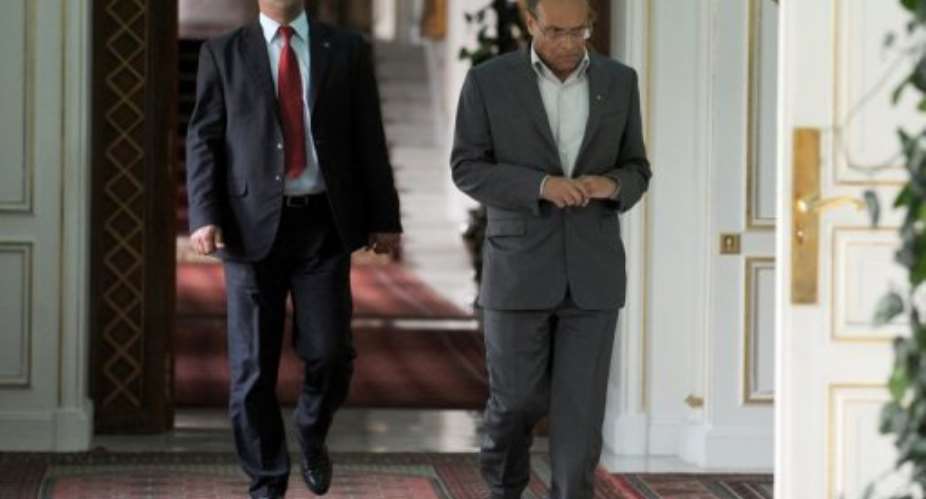 Tunisian President Moncef Marzouki (right) arrives at his office on February 19, 2013 at the Carthage palace in Tunis.  By Fethi Belaid (AFP)