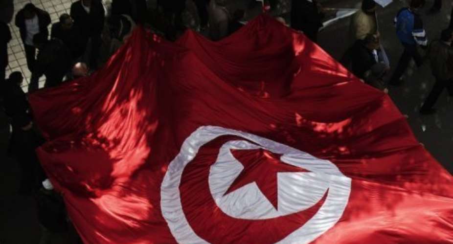 Tunisian Ennahda party supporters march through Tunis's Habib Bourguiba Avenue on February 16, 2013.  By Gianluigi Guercia AFPFile
