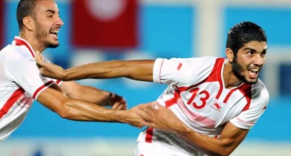 Tunisia's Ferjani Sassi R celebrates with Stephane Houcine Nater L  after scoring in Monastir on October 15, 2014.  By Salah Habibi AFPFile