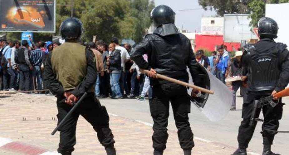 Tunisian riot police face residents of the southeastern town of Ben Guerdane during a general strike on April 2, 2014.  By Jawad Nasri AFPFile