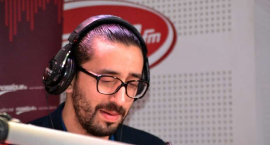 Tunisian comedian Migalo, whose real name is Wassim Lahrissi, records in the studios of the private radio station Mosaique FM on February 13, 2015 in Tunis.  By Sofiene Hamadaoui AFPFile