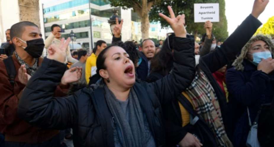 Tunisian  protesters shout slogans during an anti-government demonstration on Habib Bourguiba Avenue in the capital Tunis, on January 20, 2021Young Tunisians clashed with security forces overnight and protest organisers called for anti-government rallies after five days of riots in disadvantaged neighbourhoods..  By FETHI BELAID AFP
