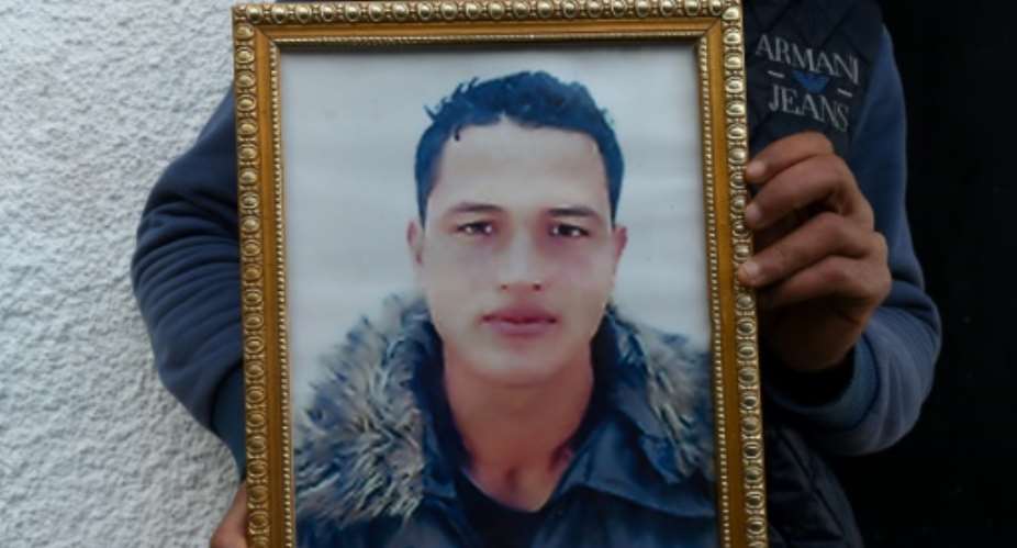 Tunisian Anis Amri (C) is believed to have hijacked a truck and used it to mow down holiday revellers in an attack on a Berlin Christmas market that left 12 people dead.  By Fethi Belaid (AFP/File)