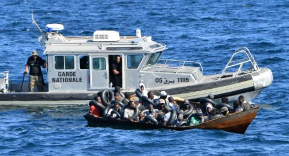 Tunisian coastguard officers intercept a migrants boat at sea, on August 10.  By FETHI BELAID (AFP/File)