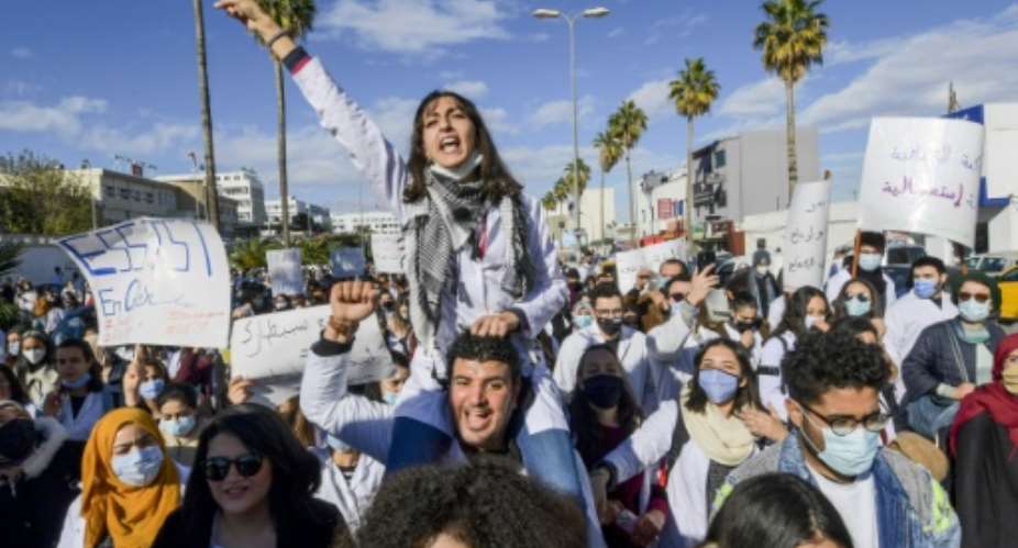 Tunisian doctors demonstrate in the capital Tunis over the country's crumbling public health infrastructure, following the death of a young doctor in a lift accident.  By FETHI BELAID AFP