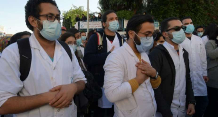 Tunisian doctors, medical students and health workers protest in front of the health ministry Friday after a young doctor died in a hospital elevator accident the day before.  By FETHI BELAID AFP