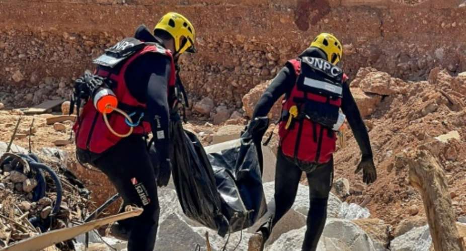 Tunisian emergency teams recover a body during relief work in Libyas devastated city of Derna.  By - (Tunisias National Office of Civil Protection/AFP)