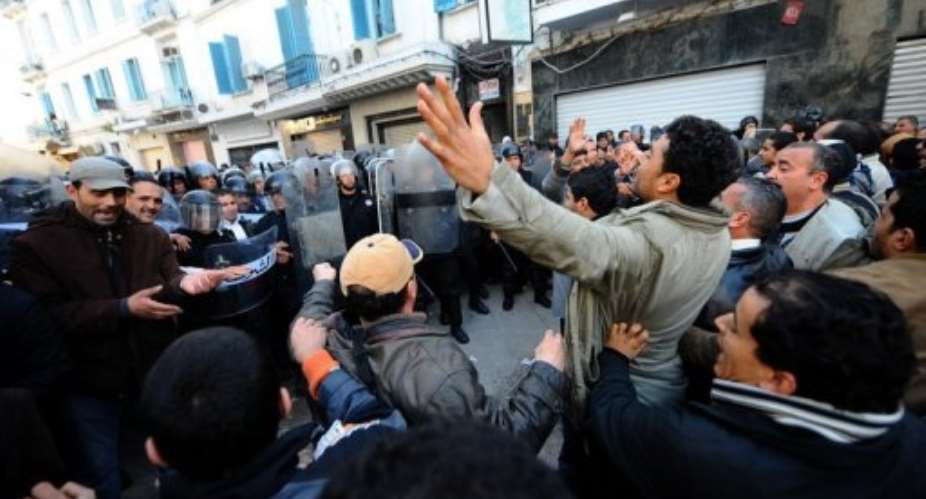 Demonstrators clash with Tunisian security force members in December 2010 in Tunis.  By Fethi Belaid AFPFile