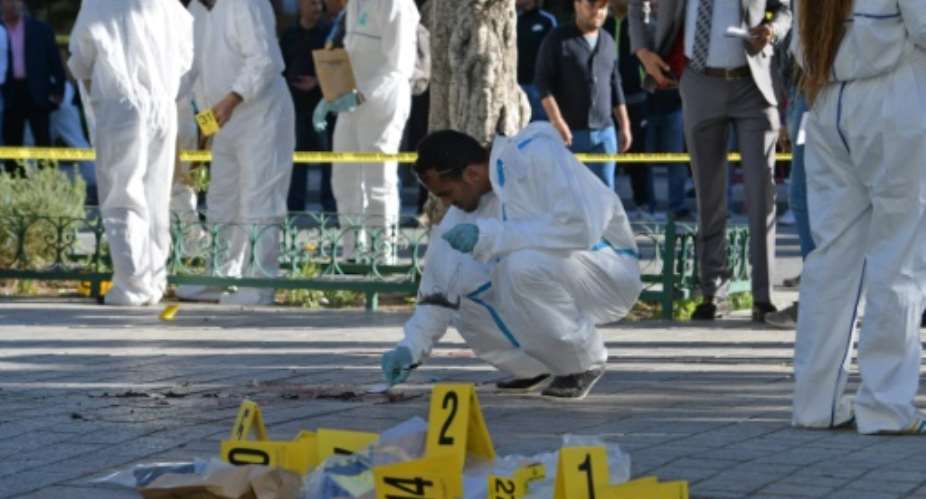 Tunisian forensics inspect the site of a suicide attack in the Tunisian capital Tunis.  By FETHI BELAID AFP