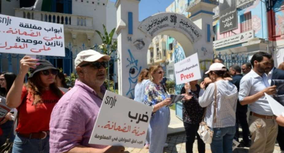 Tunisian journalists protesting outside their union headquarters.  By Sofiene HAMDAOUI (AFP)