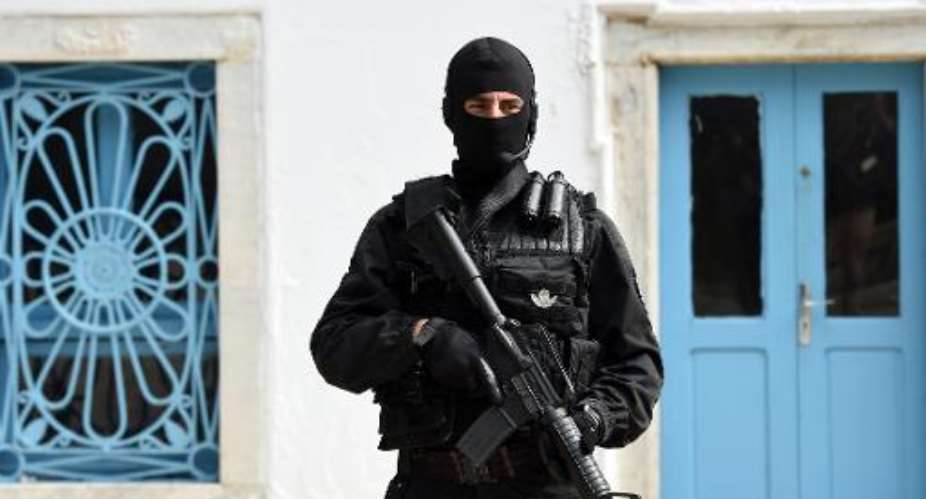 A member of Tunisia's special forces stands guard outside the Constituent Assembly in Tunis, on May 31, 2014.  By Fethi Belaid AFPFile