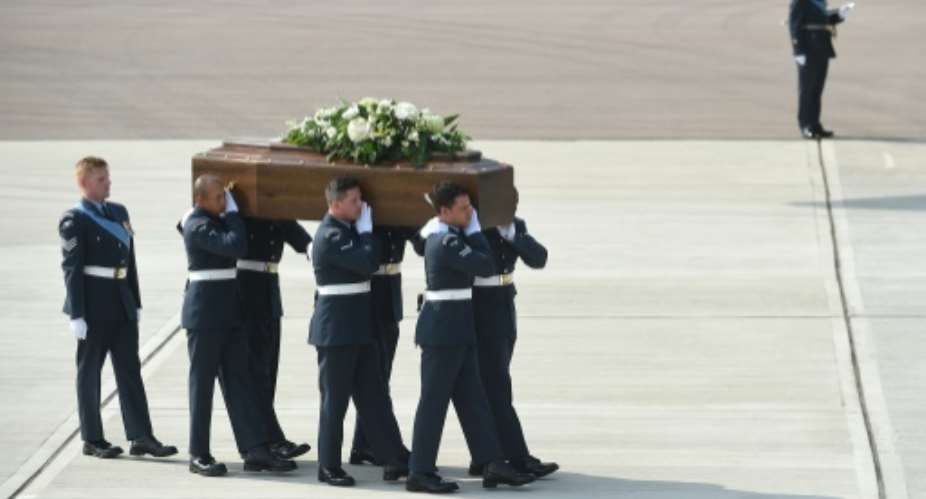 The coffin of British tourist Denis Thwaites is carried from a Royal Air Force C-17 military transporter plane at RAF Brize Norton after the attack in Tunisia, on July 1, 2015.  By Joe Giddens PoolAFPFile