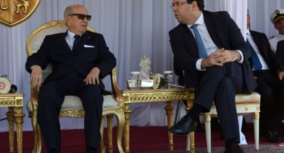 Tunisian President Beji Caid Essebsi L and Prime Minister Youssef Chahed attend a Tunisian naval drill on June 25, 2018.  By FETHI BELAID AFP