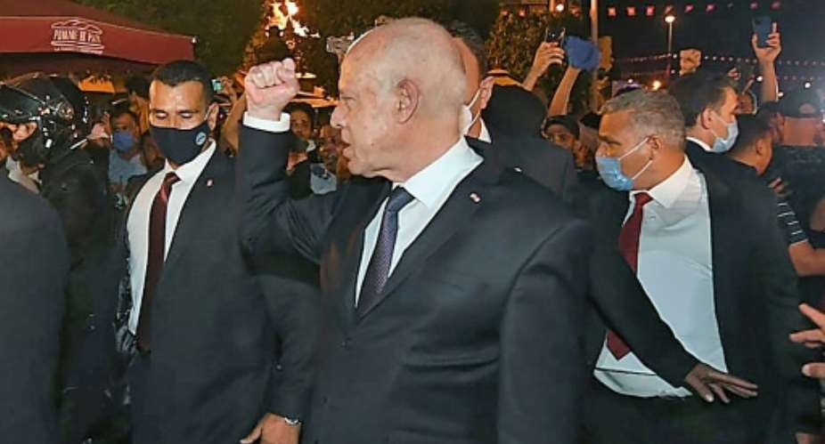 Tunisian President Kais Saied gestures to supporters on a walkabout in central Tunis the day after he launched his power grab.  By - Tunisian presidency Facebook pageAFPFile
