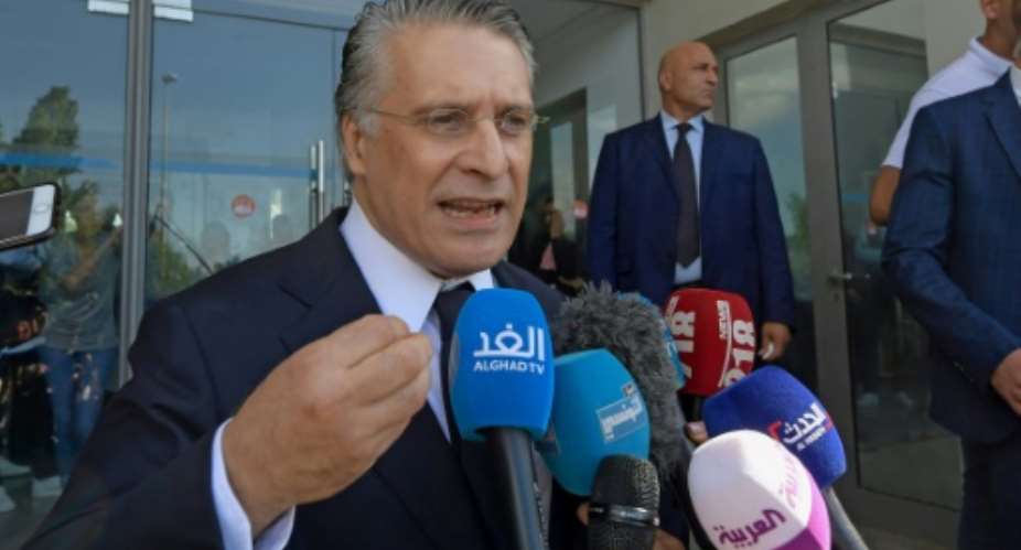 Tunisian presidential candidate Nabil Karoui speaks to journalists after being freed from jail where he was detained for over a month in connection with a money laundering probe ahead of Sunday's election runoff.  By FETHI BELAID AFP