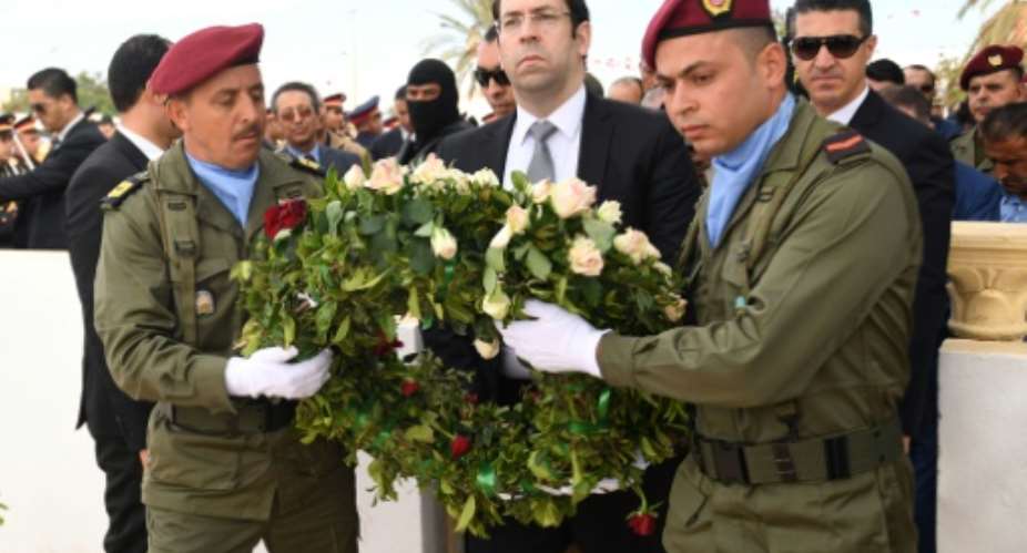 Tunisian Prime Minister Prime Minister Youssef Chahed lays a wreath for the victims of the 2016 terror attacks at a mausoleum in Ben Guerdane, on March 7, 2017.  By FETHI BELAID (AFP)
