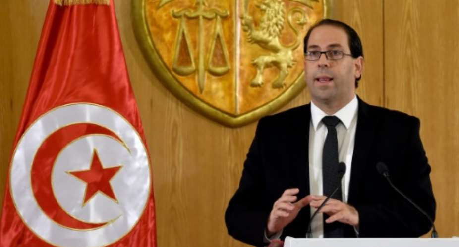Tunisian Prime Minister Youssef Chahed, seen in August 2016, said the transition to democracy was costly for his country, which relies on France for help at this critical moment.  By Fethi Belaid AFP