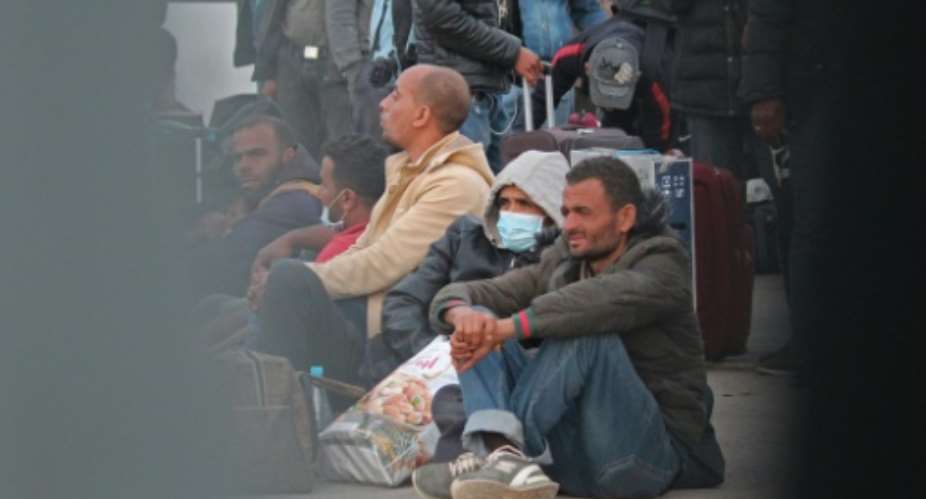 Tunisian workers stranded in war-hit Libya have returned home through the Ras Jedir crossing between the two countries despite a coronavirus lockdown.  By - AFP