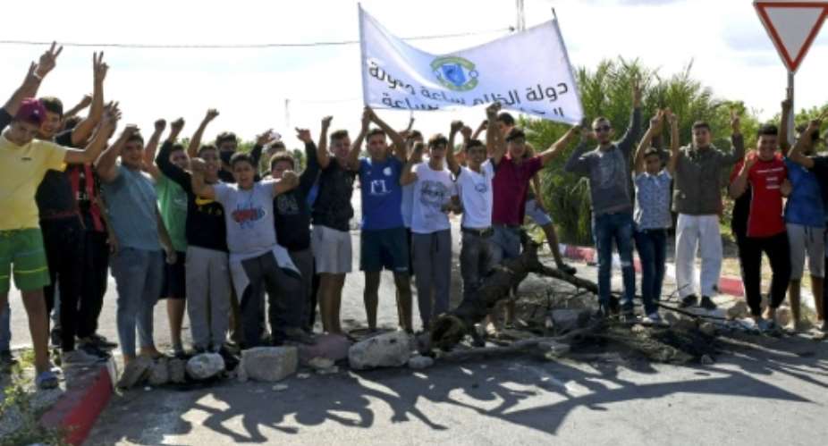 Tunisian youths prepare to burn tires and block the road leading to the city of Chebba on October 19 in protest at the Tunisian Football Federation's decision to ban their local club CS Chebba.  By Bechir TAIEB AFP