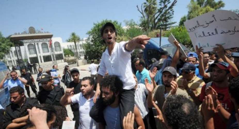 Hundreds of Tunisians protested outside the interim parliament on Tuesday.  By Fethi Belaid (AFP)