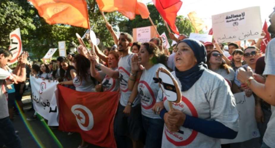 Tunisians demonstrate against a bill being discussed in parliament to grant amnesty to people accused of corruption on July 25, 2016.  By Fethi Belaid AFP