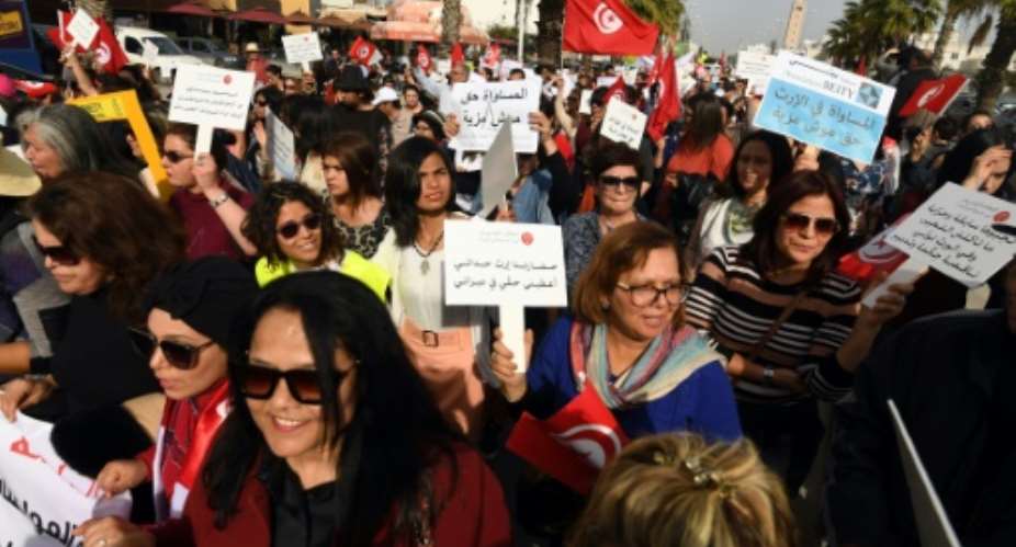 Tunisians take part in a protest to demand equal inheritance rights with men and a change to the current law based on Islamic precepts that give men the double of what women receive.  By FETHI BELAID AFP