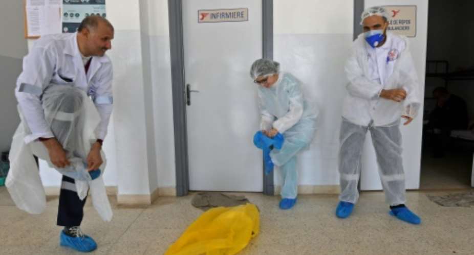 Tunisia's emergency medical care doctors pictured April 6, 2020 dress in personal protective equipment as a measure of protection against the coronvirus, before heading out to treat a COVID-19 patient in the capital Tunis.  By FETHI BELAID AFPFile