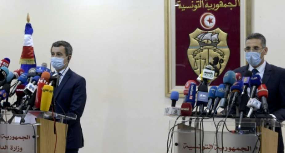 Tunisia's Interior Minister Taoufik Charfeddine R gives a joint press conference with his French counterpart Gerald Darmanin in the capital Tunis on Friday.  By FETHI BELAID AFP