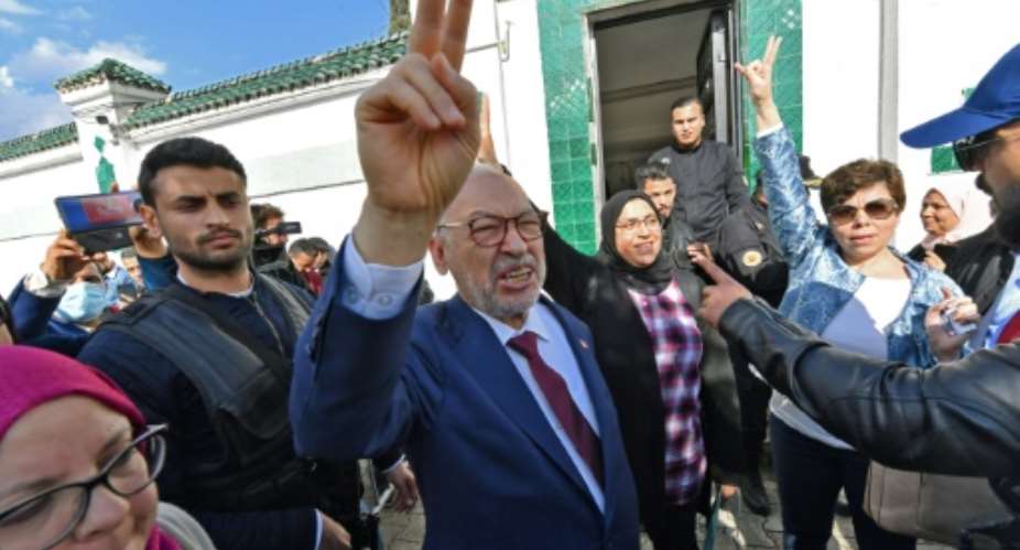 Tunisia's speaker of the dissolved parliament, Rached Ghannouchi, flashes the victory sign as he arrives for questioning at the judicial police headquarters in the capital Tunis.  By FETHI BELAID AFP