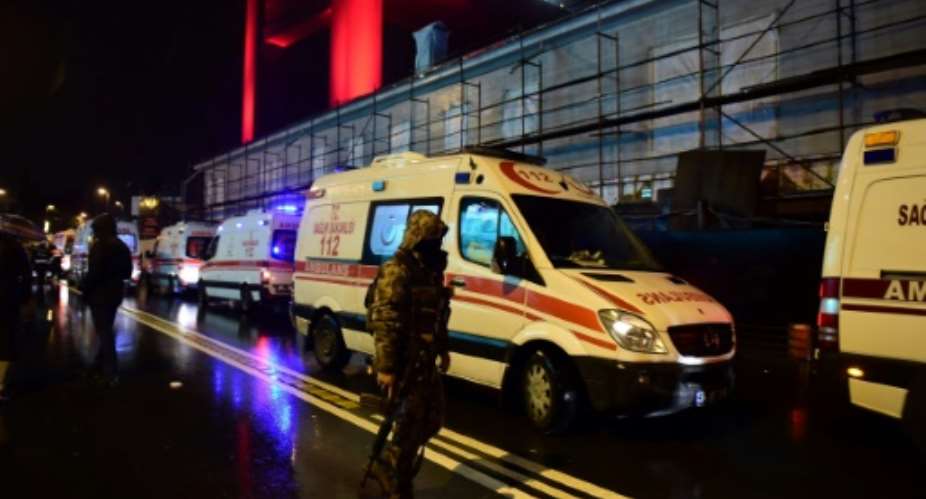 Turkish special force police officers and ambulances are seen at the site of an armed attack at the Reina nightclub in Istanbul on January 1, 2017.  By YASIN AKGUL AFP