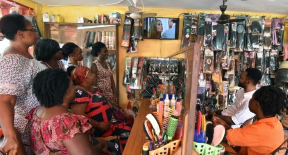 TV channels schedule telenovelas to run during the day in Ivory Coast -- aiming to hook not just housewives but women with TVs in their workplaces, such as hairdressers.  By Sia KAMBOU AFP
