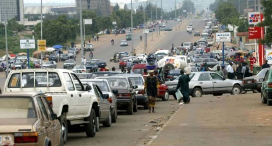 Motorists rush to buy petrol in Abuja in 2003.  By Pius Utomi Ekpei AFPFile