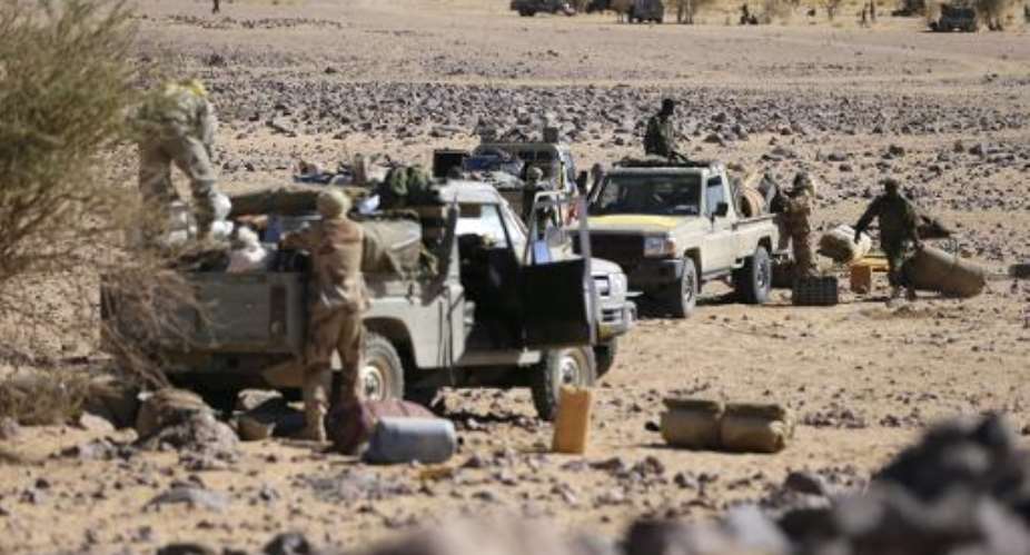 Chadian troops prepare their vehicles before patrolling the desert near Tessalit on March 14, 2013.  By Kenzo Tribouillard (AFP/File)