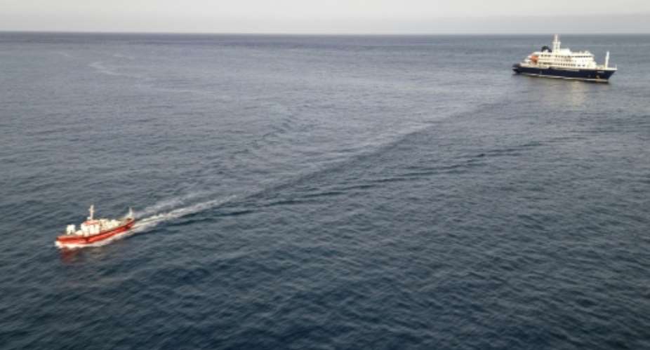 Two crew members and one other person thought to be infected were taken off the ship.  By - (AFP)