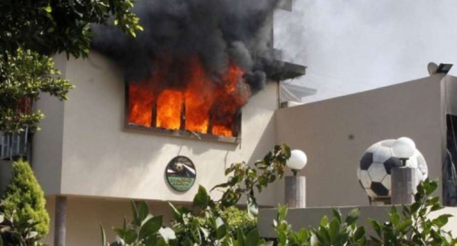Flames rise from a room at the headquarters of the Egyptian Football Association in Cairo on March 9, 2013.  By  AFP