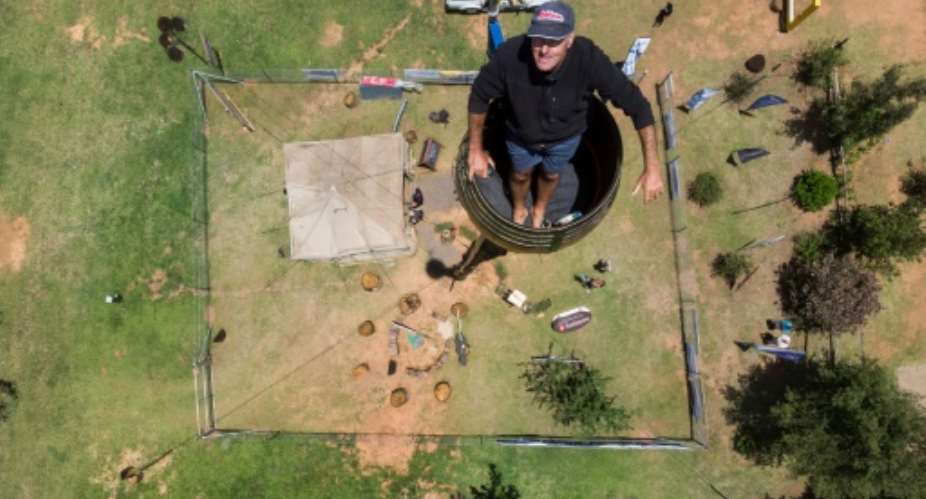 Two decades on from his initial effort, Kruger, 52, is on the verge of smashing his record for sitting in a pole 25 metres above the ground.  By ANTOINE DEMAISON AFP