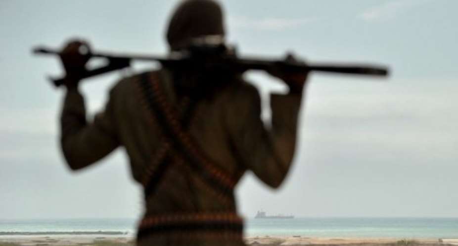 A pirate boss stands on sandy dunes just outside the central Somali coastal town of Hobyo in 2010.  By Roberto Schmidt (AFP/File)