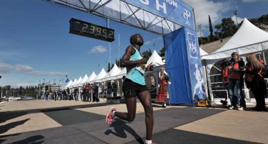 Kenyan women's third placed, Chelengat Viola Kimetto, crosses the finish line of the 30th Athens Classic Marathon at the Athens Panathenaen stadium on November 11, 2012.  By Louisa Gouliamaki AFPFile