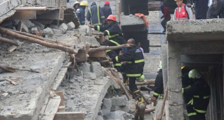 Kenyan rescuers arrive at the scene after a building collapsed.  By Simon Maina AFP