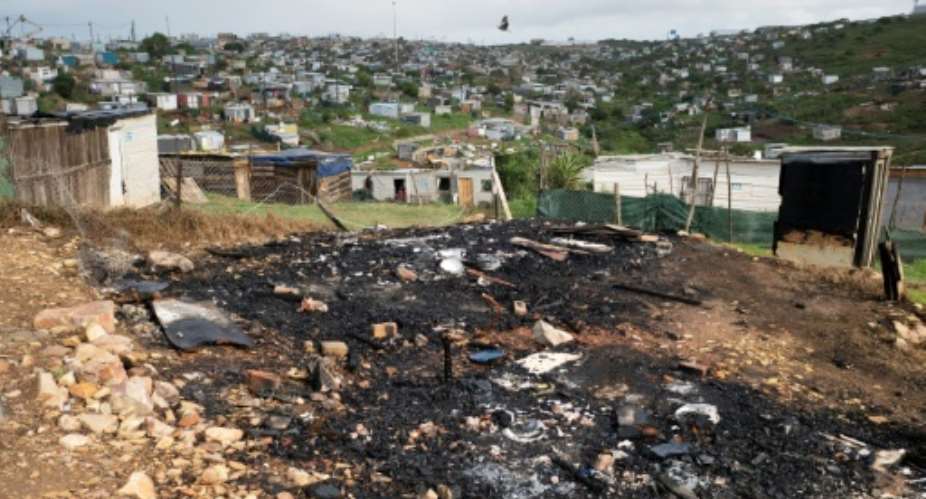 Two Mozambican nationals were killed and several houses torched after a march against undocumented foreign nationals.  By RODGER BOSCH (AFP)