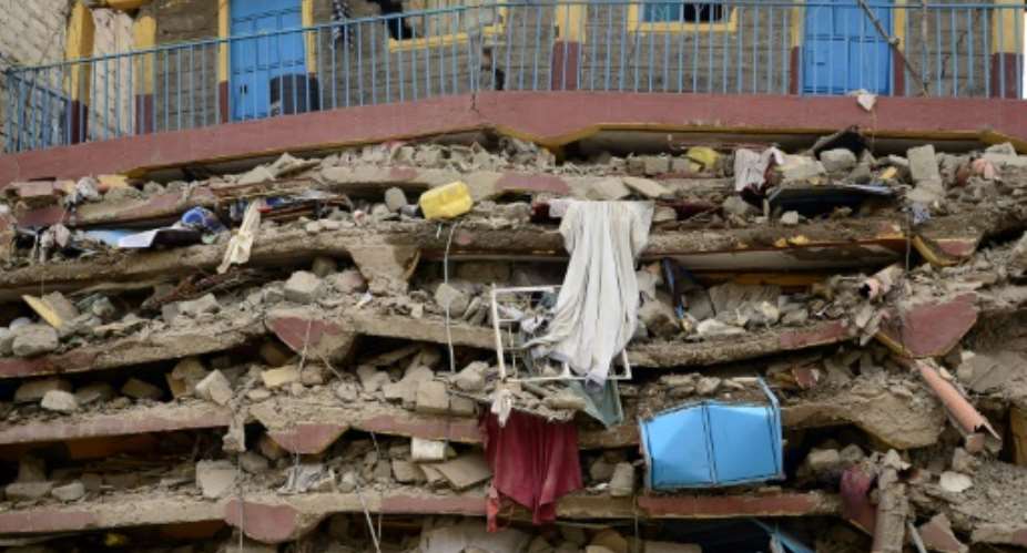 Two people have died after being pulled from the collapsed building in Nairobi but the search goes on for other survivors.  By John MUCHUCHA AFPFile